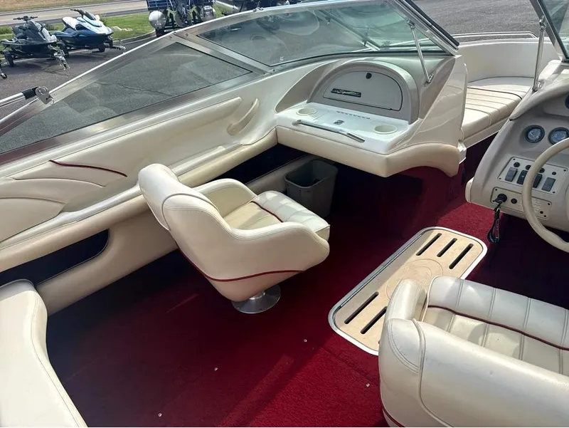 Slide: The Image of Interior of a 1996 Sea Ray 210 Signature with white leather seats and red carpet. - 11
