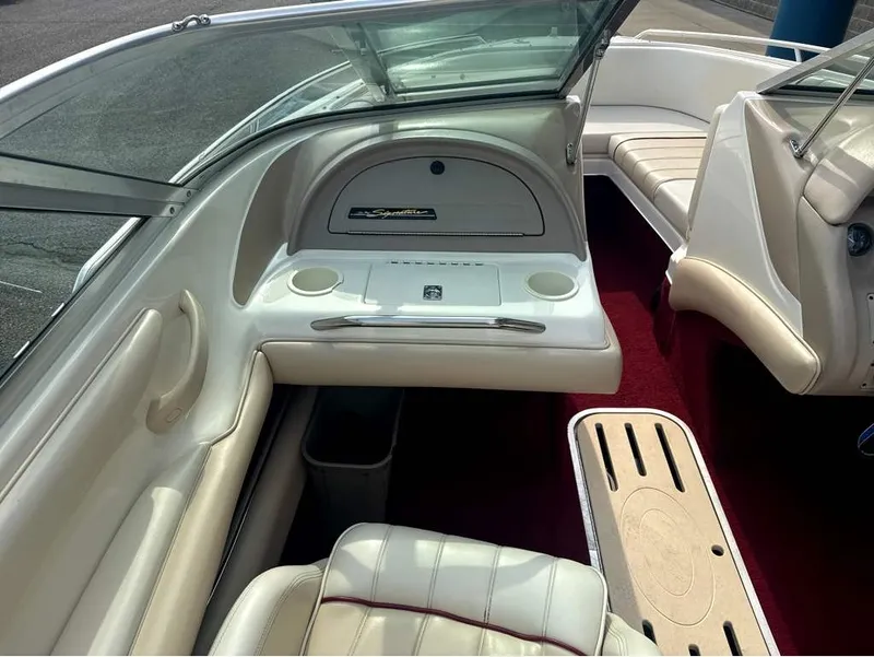 Slide: The Image of The image shows the cockpit of a 1996 Sea Ray 210 Signature with white leather seats and red carpeting. - 12