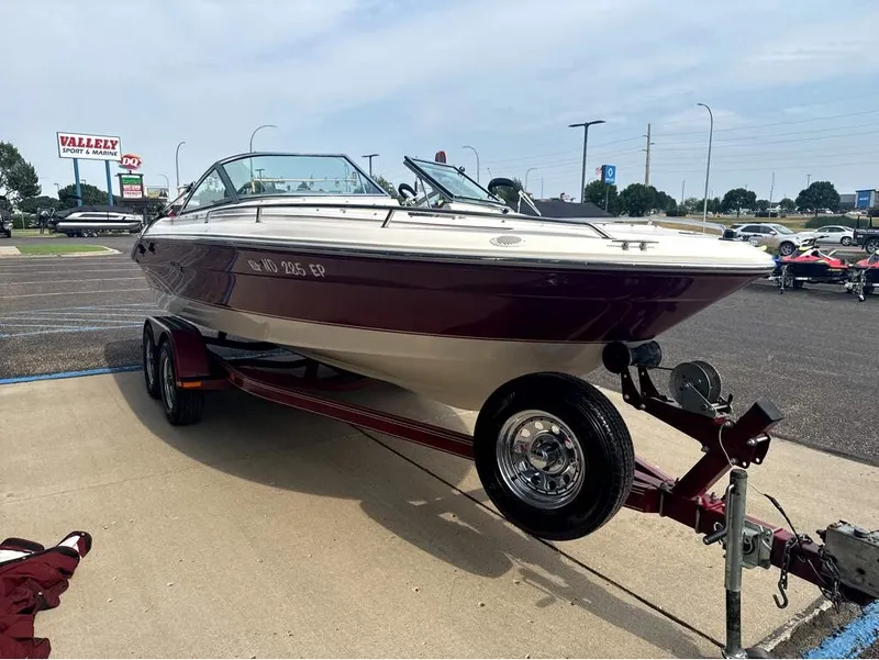 Slide: The Image of A 1996 Sea Ray 210 Signature boat on a trailer, parked in a lot. - 7