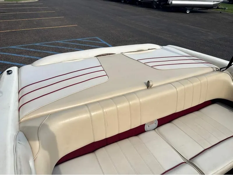 Slide: The Image of The image shows the upholstered rear of a 1996 Sea Ray 210 Signature boat. - 8