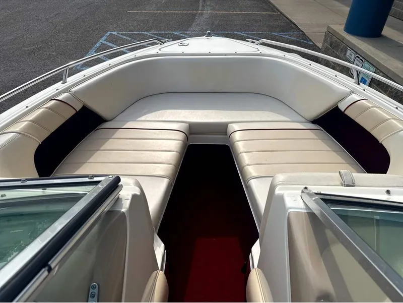 Slide: The Image of The image shows the bow of a 1996 Sea Ray 210 Signature boat with beige upholstery. - 15