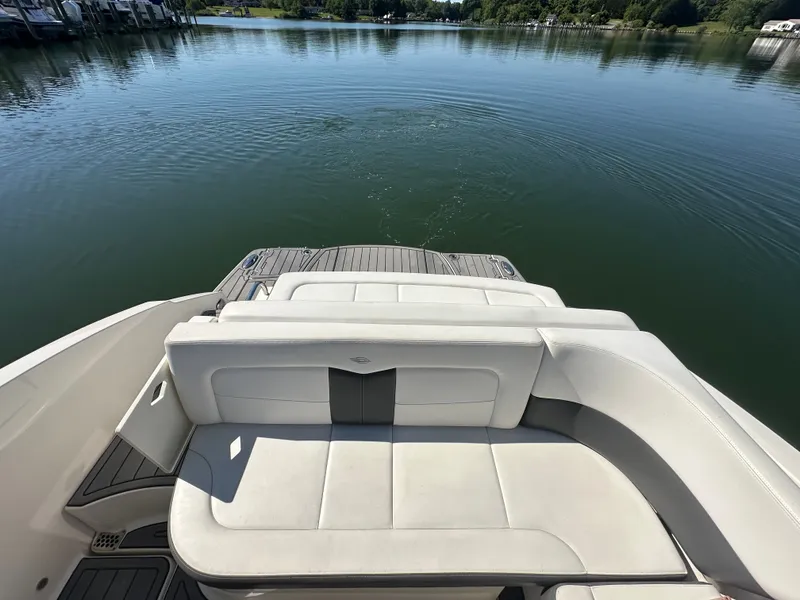 Slide: The Image of The image shows the stern of a Chaparral 337 SSX boat on a calm lake. - 11