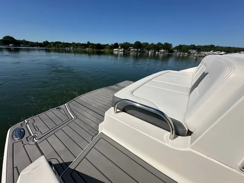 Slide: The Image of The image shows the stern of a 2016 Chaparral 337 SSX boat on a calm lake. - 12
