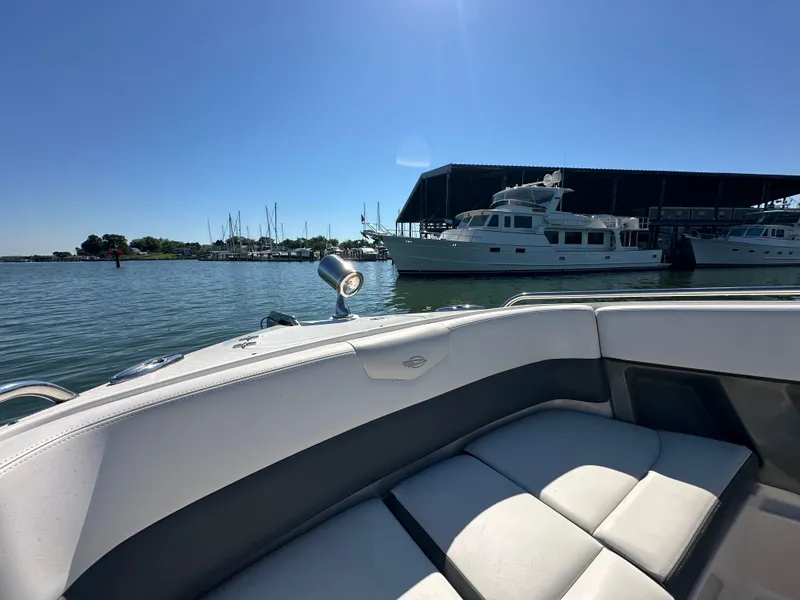 Slide: The Image of A 2016 Chaparral 337 SSX is on the water, with a marina in the background. - 21