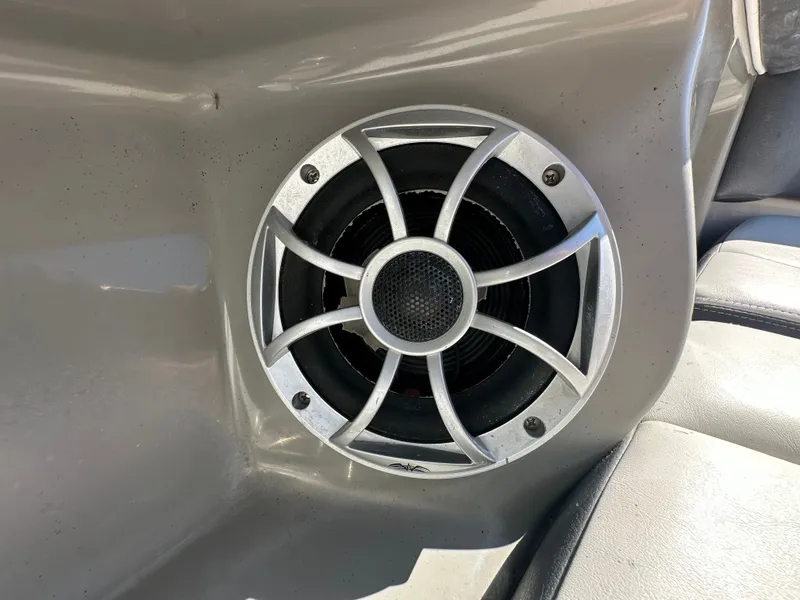 Slide: The Image of Close-up of a speaker in a gray boat interior. - 23