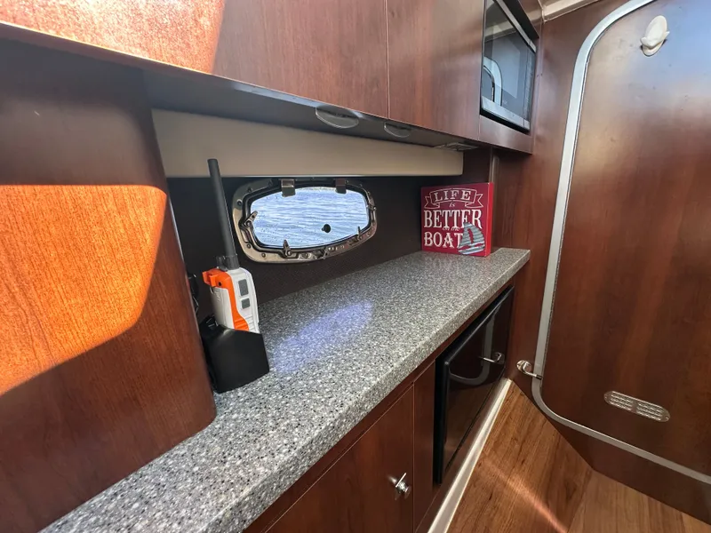 Slide: The Image of Interior of a Chaparral 337 SSX with wood paneling, granite countertop, and a small window. - 34