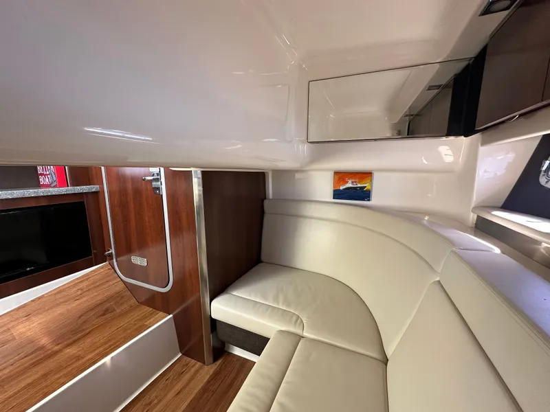 Slide: The Image of Interior of a 2016 Chaparral 337 SSX with sleek leather seating and wooden flooring. - 38