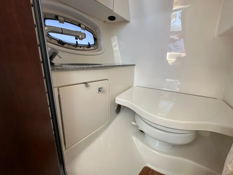 Slide: The Image of Interior view of a boat bathroom with a toilet and sink. - 39