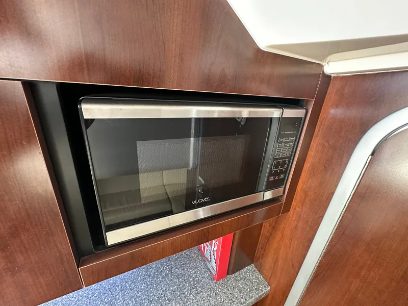 Slide: The Image of A microwave is built into a wooden kitchen unit. - 42