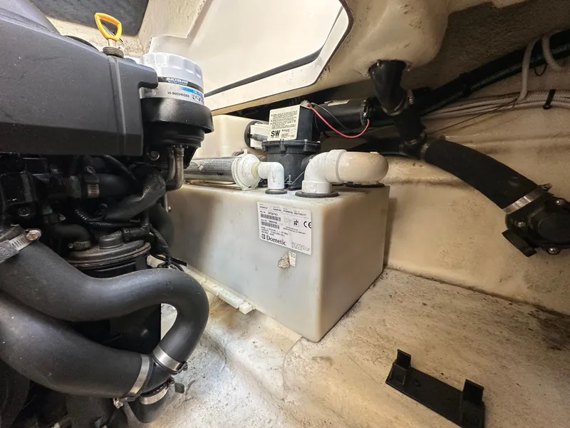 Slide: The Image of An engine compartment with a motor and water tank inside a boat. - 8