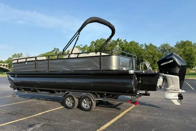 Slide: The Image of 2024 Regency 250 DL3 pontoon boat with Mercury engine, parked on a trailer in a lot. - 10