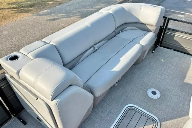 Slide: The Image of 2024 Regency 250 DL3 pontoon boat with luxurious gray seating and cup holder. - 19