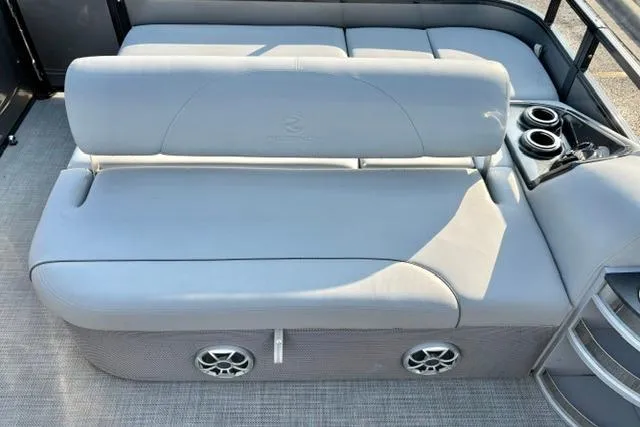Slide: The Image of 2024 Regency 250 DL3 boat interior with plush seating and built-in cup holders. - 24
