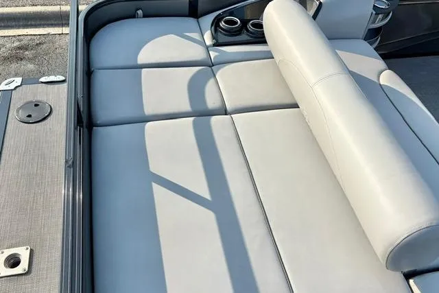 Slide: The Image of 2024 Regency 250 DL3 boat interior with gray cushioned seating and cup holders. - 25