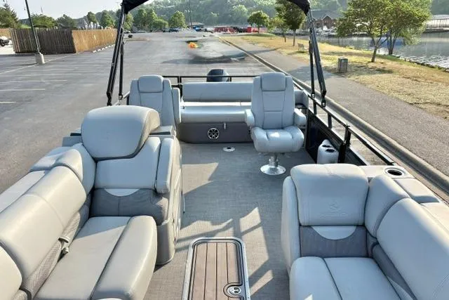 Slide: The Image of 2024 Regency 250 DL3 pontoon boat with spacious seating and modern design. - 26