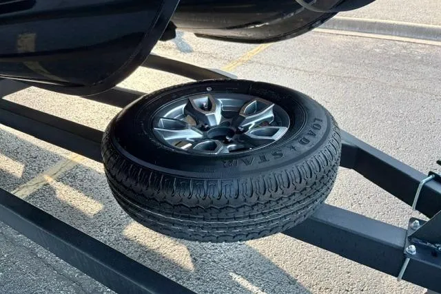 Slide: The Image of 2024 Regency 250 DL3 trailer with spare tire mounted on frame. - 27