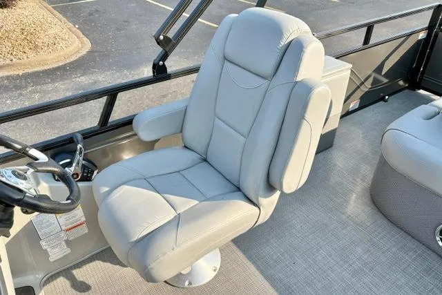 Slide: The Image of Luxurious captain's chair on 2024 Regency 250 DL3 pontoon boat, featuring plush gray upholstery. - 28