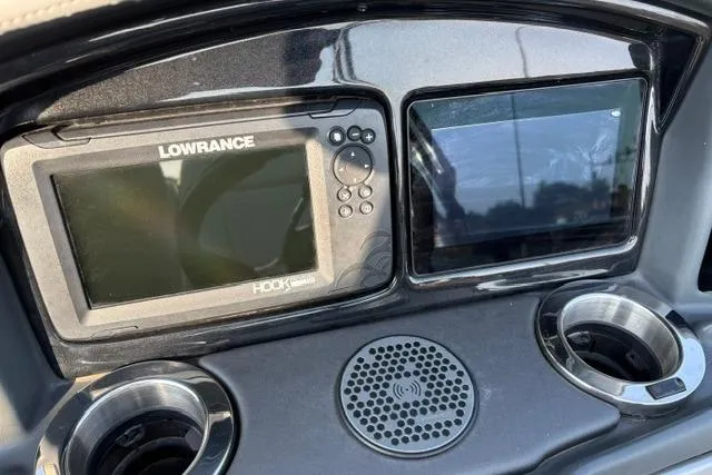 Slide: The Image of Dashboard of 2024 Regency 250 DL3 with Lowrance Hook display and cup holders. - 29