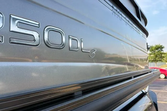 Slide: The Image of 2024 Regency 250 DL3 boat exterior with sleek metallic finish and model emblem. - 32