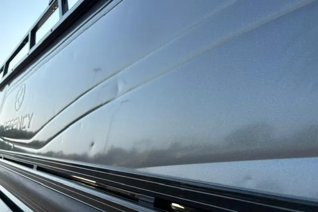 Slide: The Image of 2024 Regency 250 DL3 boat side view, showcasing sleek metallic finish and design details. - 36