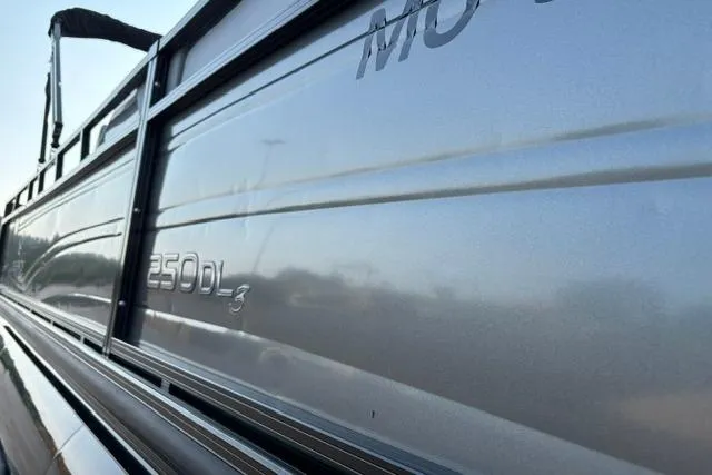Slide: The Image of 2024 Regency 250 DL3 boat side view with sleek metallic finish. - 38