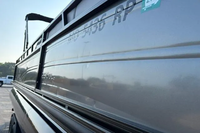 Slide: The Image of 2024 Regency 250 DL3 boat side view with sleek metallic finish. - 39
