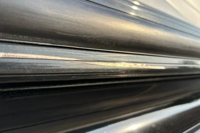 Slide: The Image of Close-up of 2024 Regency 250 DL3 metallic surface with sleek, reflective lines. - 41