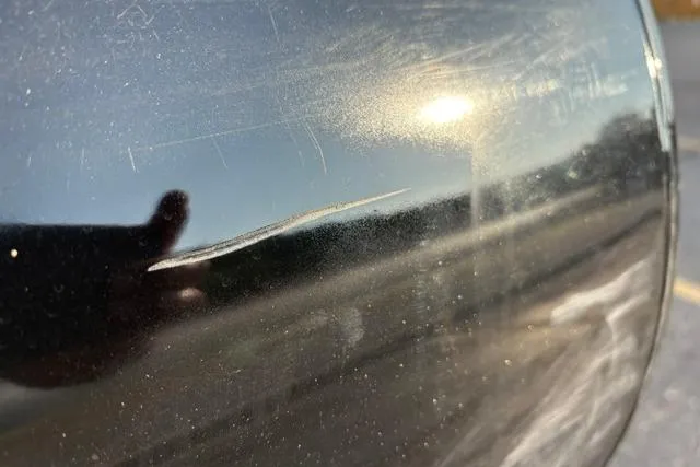 Slide: The Image of Close-up of a scratch on a 2024 Regency 250 DL3's black surface. - 43