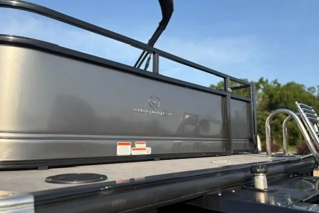 Slide: The Image of 2024 Regency 250 DL3 pontoon boat, sleek design, side view, sunny day. - 50