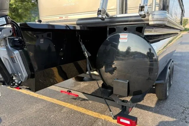 Slide: The Image of 2024 Regency 250 DL3 boat trailer hitch and rear view in a parking lot. - 51