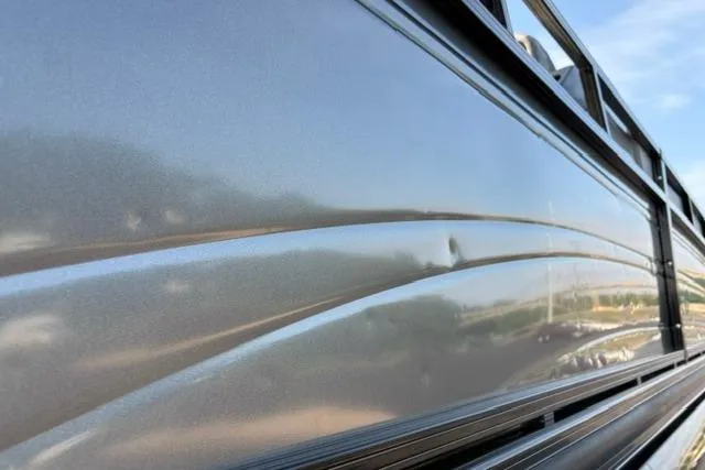 Slide: The Image of 2024 Regency 250 DL3 boat exterior with sleek metallic finish and modern design. - 53