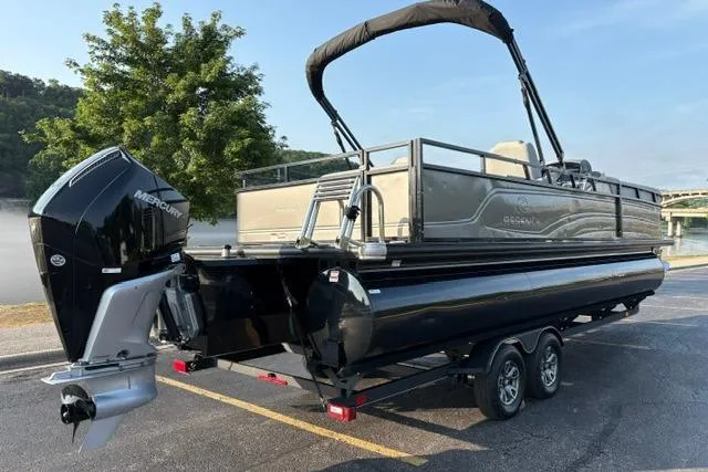 Slide: The Image of 2024 Regency 250 DL3 pontoon boat with Mercury outboard engine on a trailer. - 7