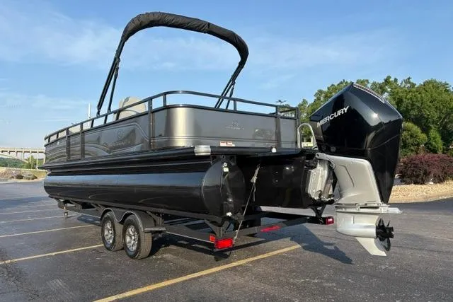 Slide: The Image of 2024 Regency 250 DL3 pontoon boat with Mercury outboard engine on a trailer. - 8