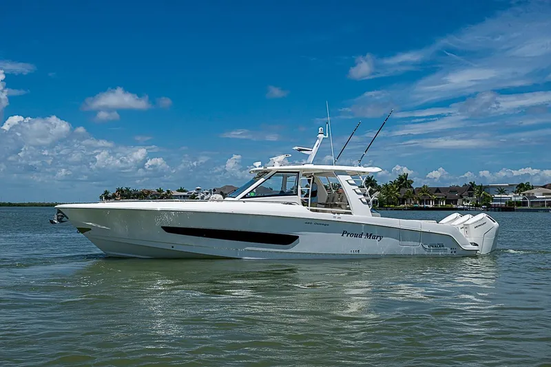 The Image of 2022 Boston Whaler 420 Outrage boat on calm water under a clear blue sky. - 0