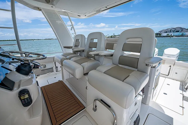 Slide: The Image of 2022 Boston Whaler 420 Outrage helm with luxurious seating and ocean view. - 10