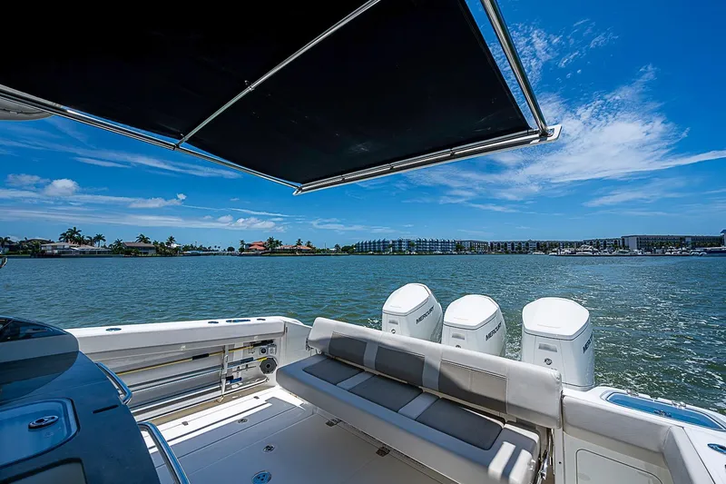 Slide: The Image of 2022 Boston Whaler 420 Outrage boat with triple Mercury engines on a sunny day. - 17