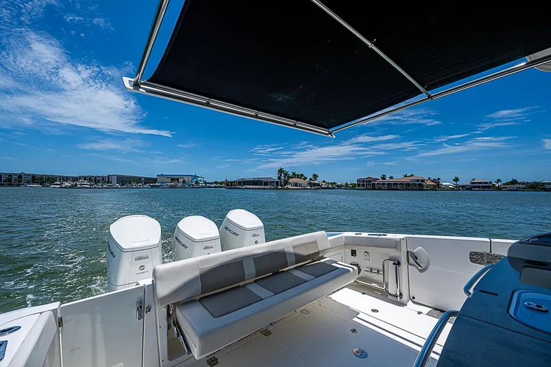 Slide: The Image of Boston Whaler 420 Outrage 2022 boat with triple Mercury engines on a sunny day. - 18