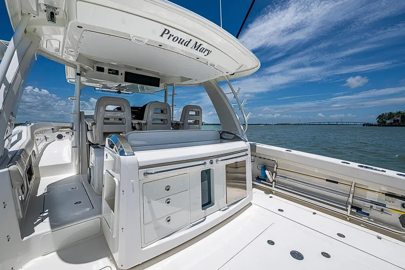 Slide: The Image of 2022 Boston Whaler 420 Outrage boat interior with seating and ocean view. - 19
