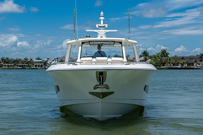 Slide: The Image of 2022 Boston Whaler 420 Outrage boat on calm water with scenic background. - 2