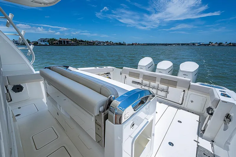 Slide: The Image of 2022 Boston Whaler 420 Outrage boat with triple engines on a sunny day. - 21