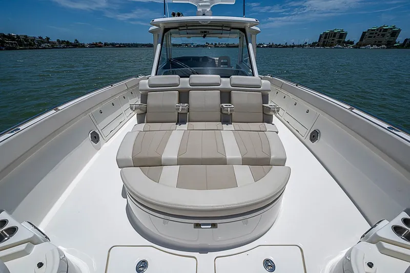 Slide: The Image of 2022 Boston Whaler 420 Outrage boat interior with luxurious seating on calm water. - 24