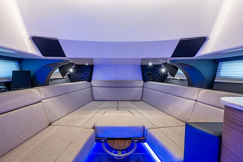 Slide: The Image of Luxurious interior of 2022 Boston Whaler 420 Outrage with plush seating and ambient lighting. - 29