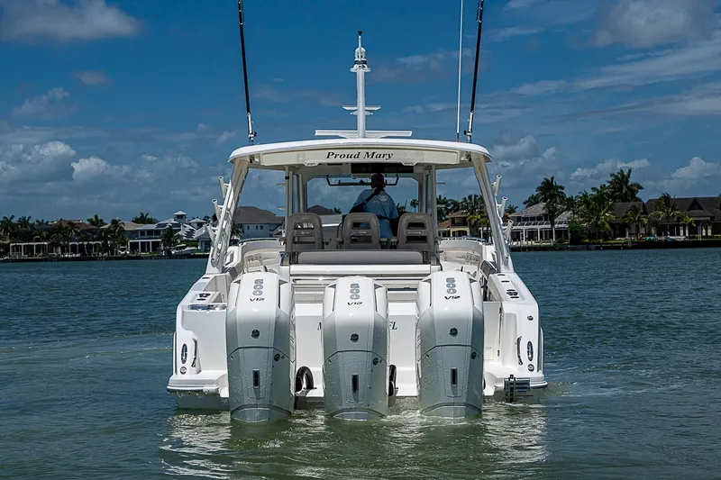 Slide: The Image of 2022 Boston Whaler 420 Outrage boat with triple engines on a sunny day. - 3