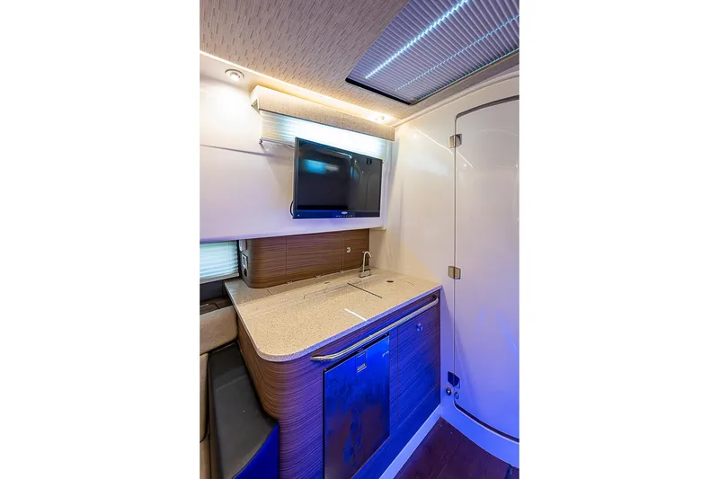 Slide: The Image of Luxurious interior of 2022 Boston Whaler 420 Outrage with modern kitchenette and sleek design. - 30