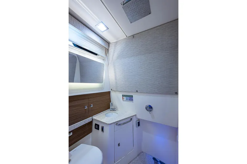 Slide: The Image of Luxurious bathroom interior of 2022 Boston Whaler 420 Outrage boat, featuring modern fixtures. - 33