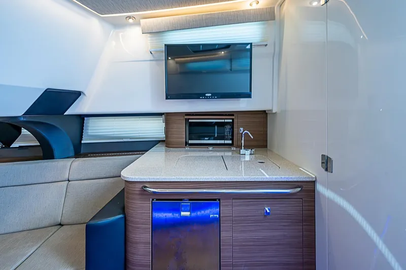 Slide: The Image of Luxurious interior of 2022 Boston Whaler 420 Outrage featuring modern kitchenette and seating area. - 35