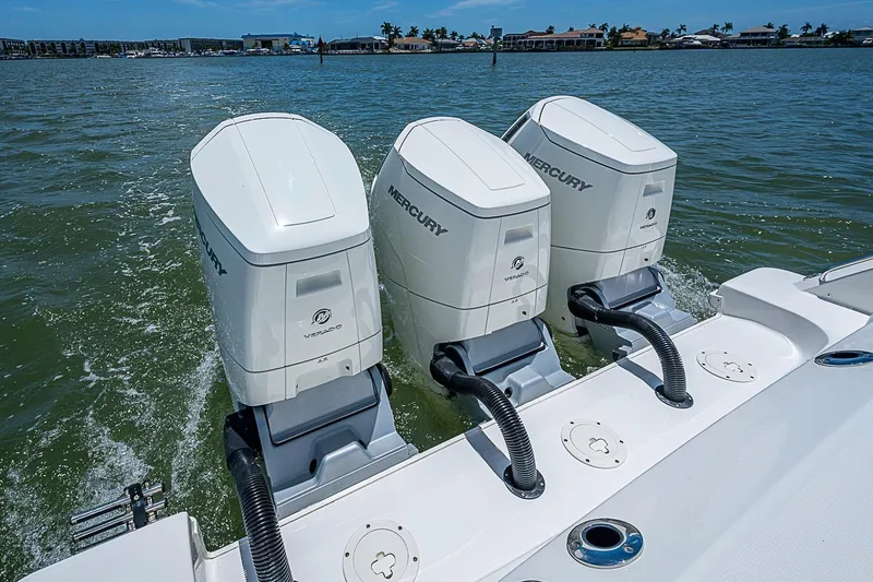 Slide: The Image of Triple Mercury Verado engines on a 2022 Boston Whaler 420 Outrage in open water. - 39