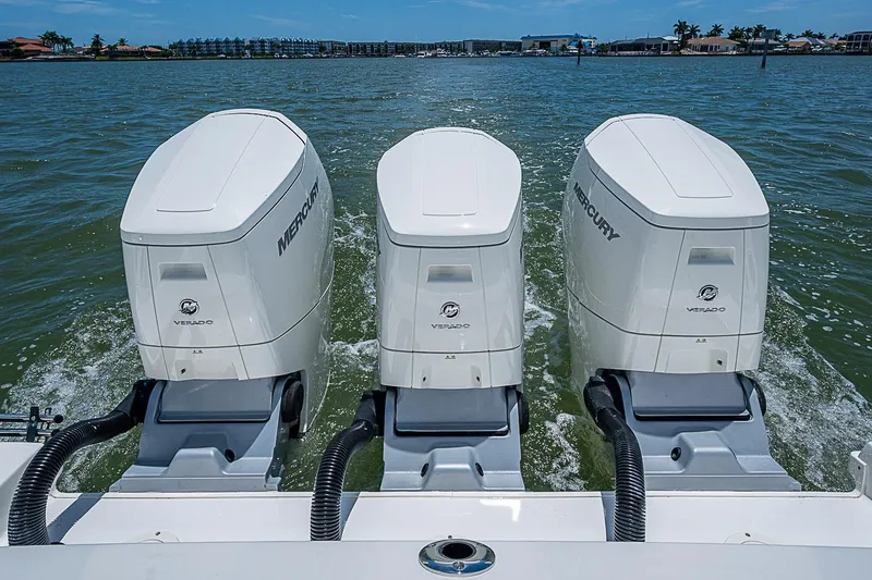 Slide: The Image of Triple Mercury Verado engines powering a 2022 Boston Whaler 420 Outrage on open water. - 40