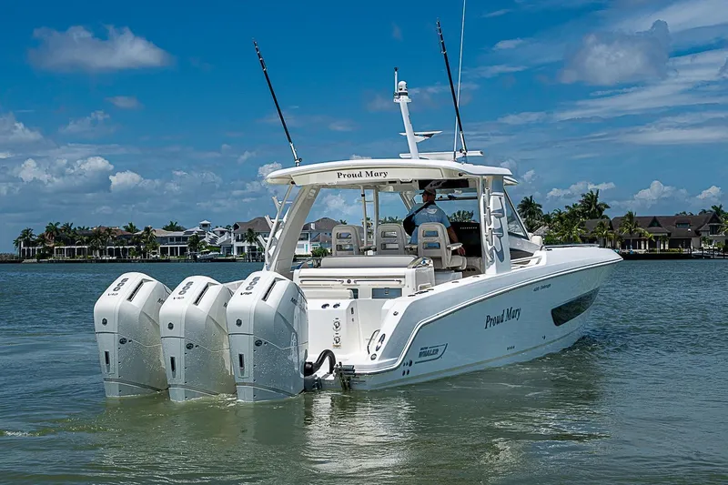 Slide: The Image of 2022 Boston Whaler 420 Outrage boat cruising on a sunny day with triple engines. - 42