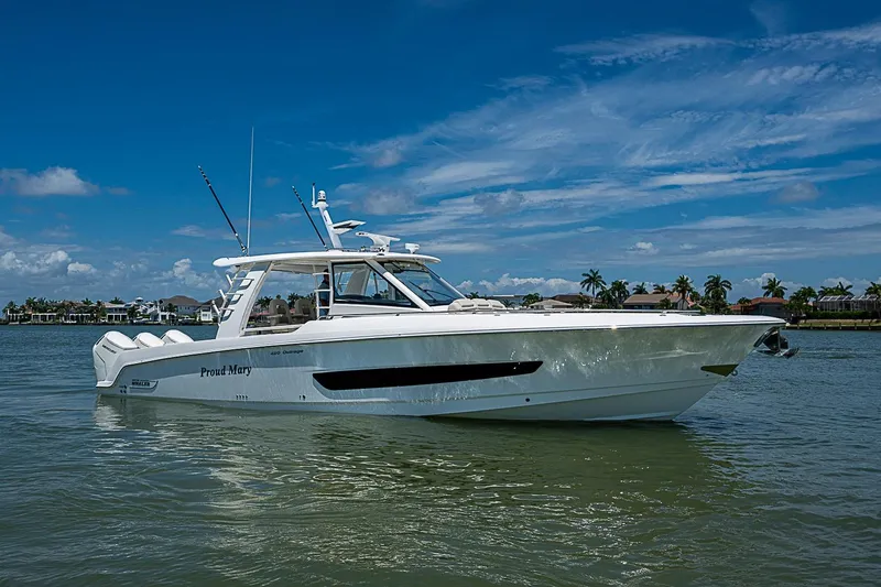 Slide: The Image of 2022 Boston Whaler 420 Outrage boat on calm water under a clear blue sky. - 43